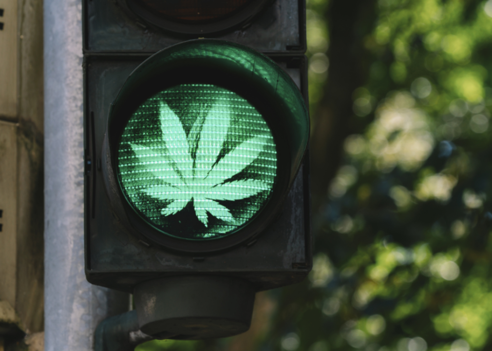 A traffic light with a green cannabis leaf.