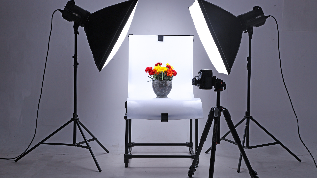 Two softbox lights being used to illuminate a flower vase for a product photography shot