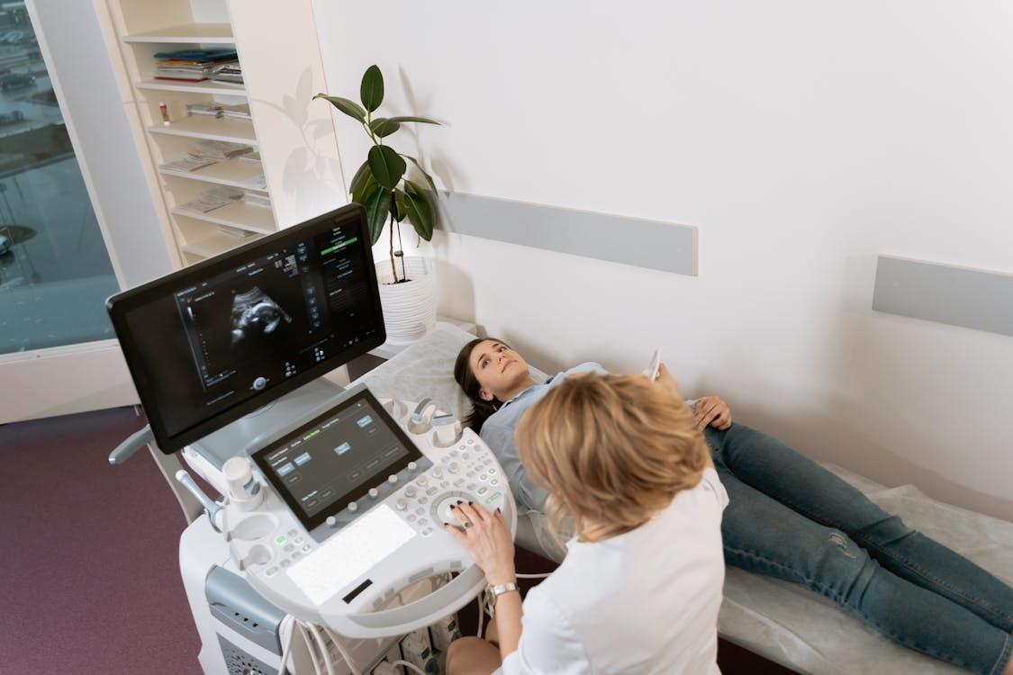 Doctor performing pelvic scan on patient