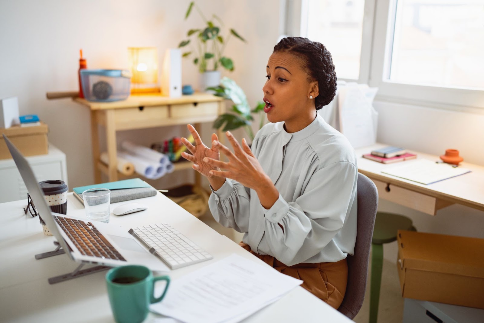 Woman watching screen gesticulating with hands