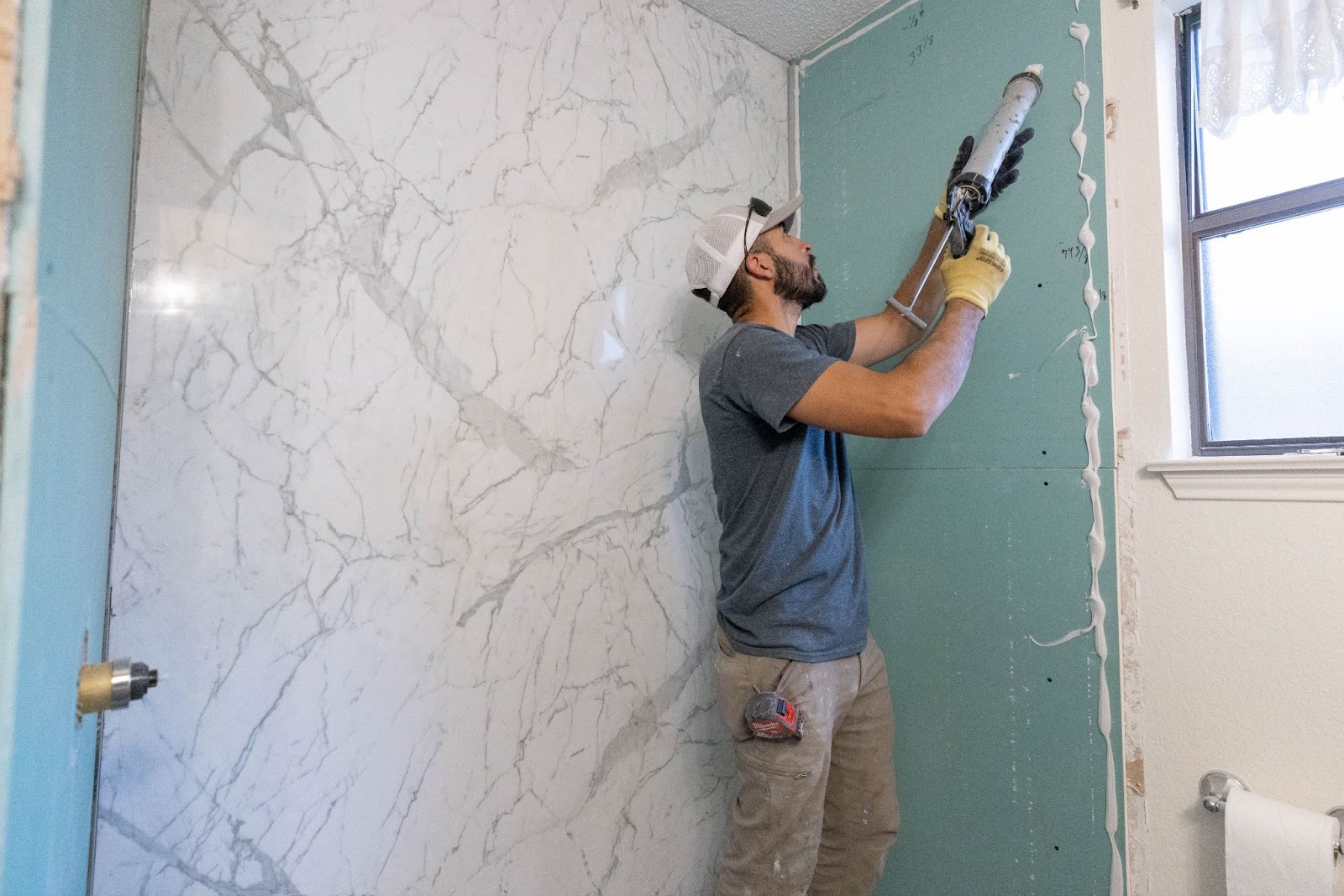 A ZINTEX contractor installs a walk-in shower system