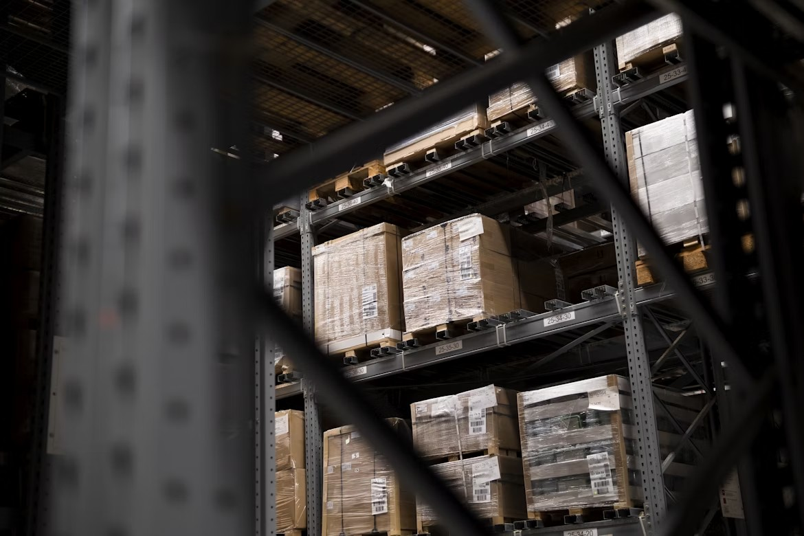 Shelves with palletized goods in a pre-engineered steel mini storage facility.