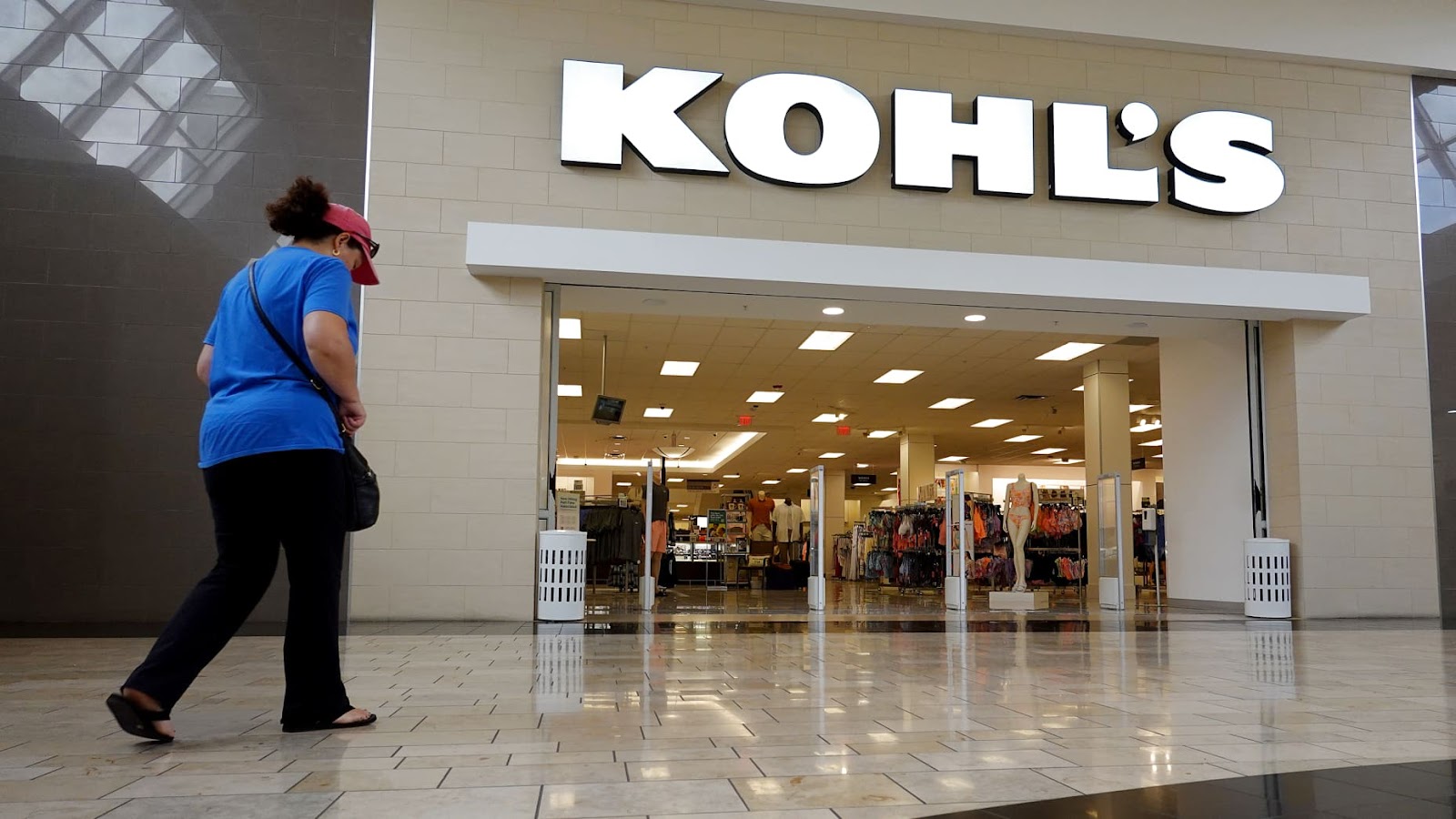 DORAL, FLORIDA - JUNE 07: A person walks near a Kohl's department store entranceway on June 07, 2022 in Doral, Florida. Kohl’s announced that it has entered into exclusive negotiations with Franchise Group, which is proposing to buy the retailer for $60 per share. (Photo by Joe Raedle/Getty Images)