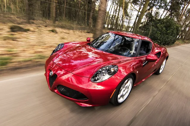 red sport car speeding on road