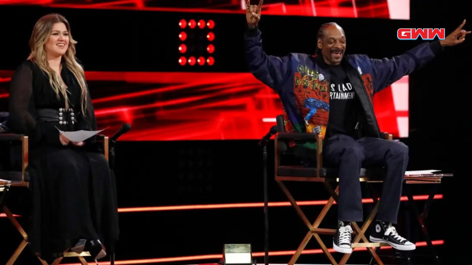 Snoop Dogg enthusiastically coaches a contestant on The Voice stage