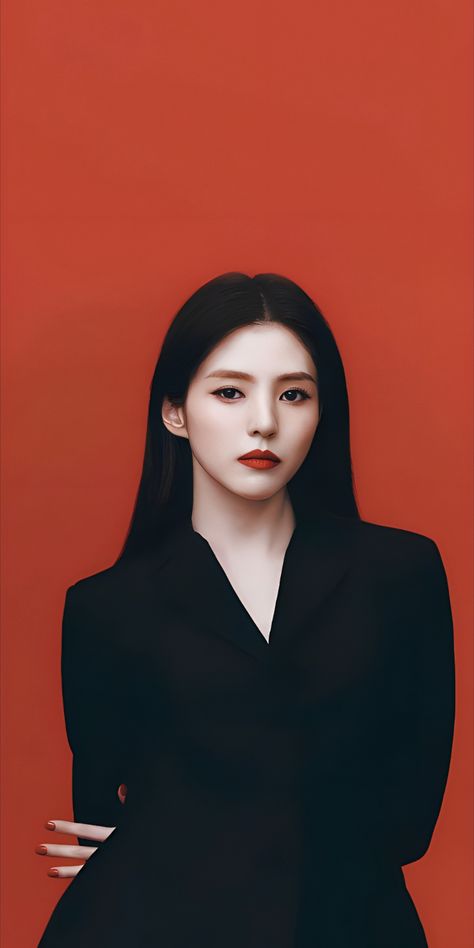 A photo of Han So hee on a black dress and her hand at her back on a red back ground looking amazing 