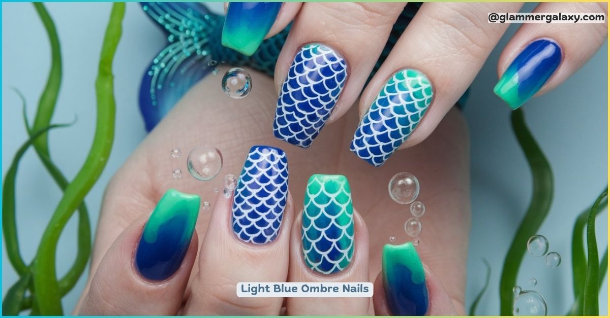 A photo of light blue ombre nails with mermaid scale nail art.

