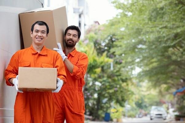 A couple of men carrying boxes
AI-generated content may be incorrect.