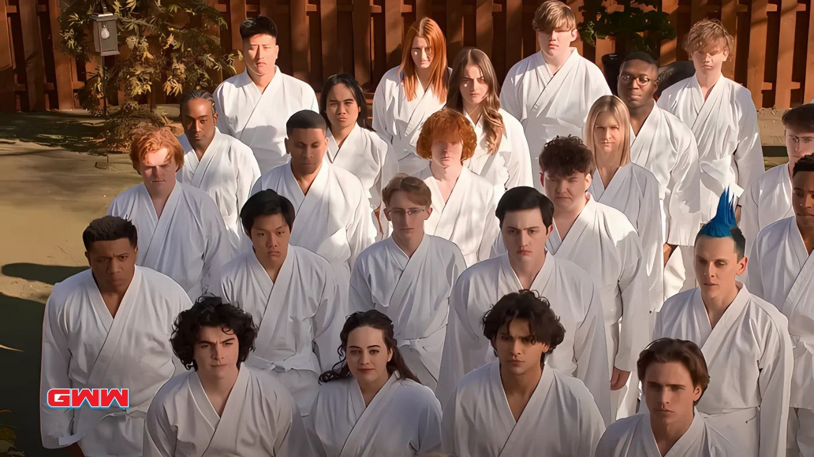 Cobra Kai students in white gi, including Xolo Maridueña and Jacob Bertrand