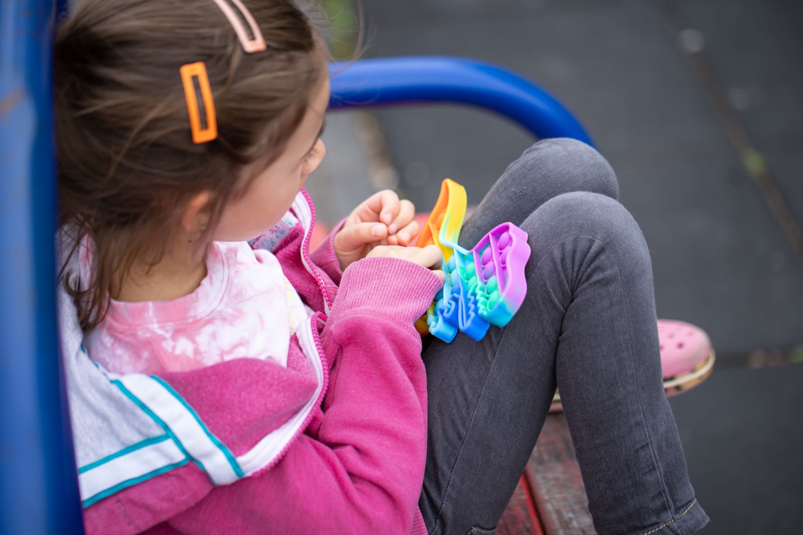 A girl playing with a toy fidget push pop