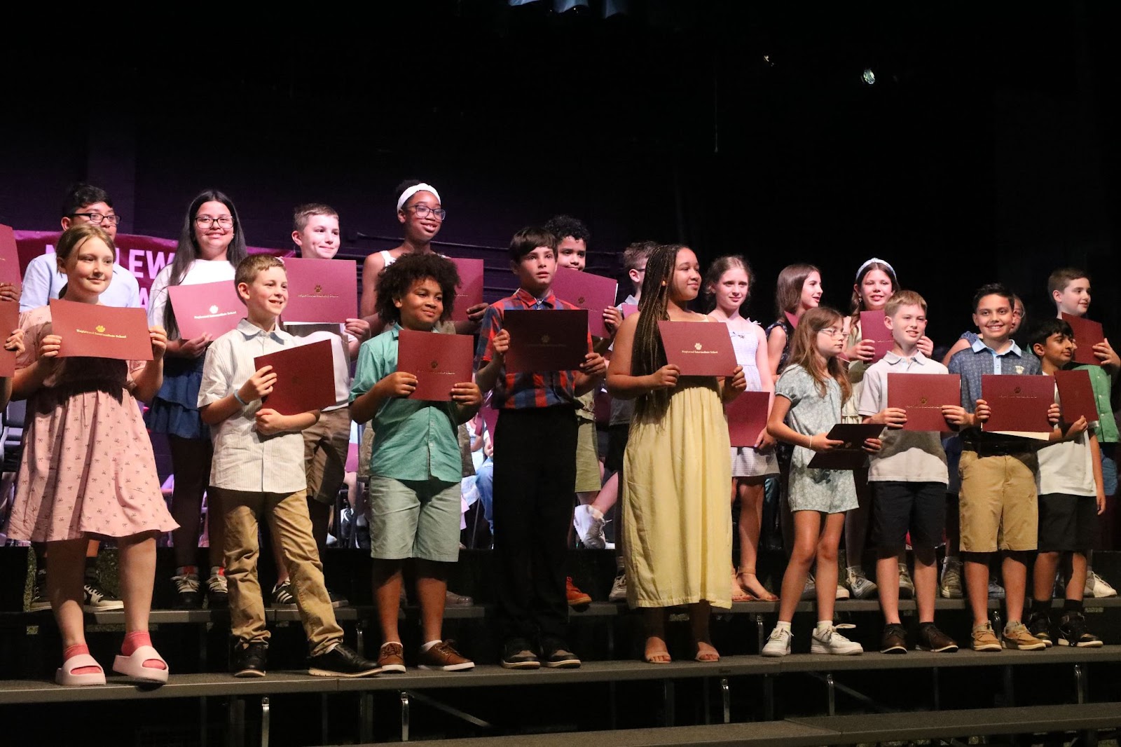 kids on risers with certificates