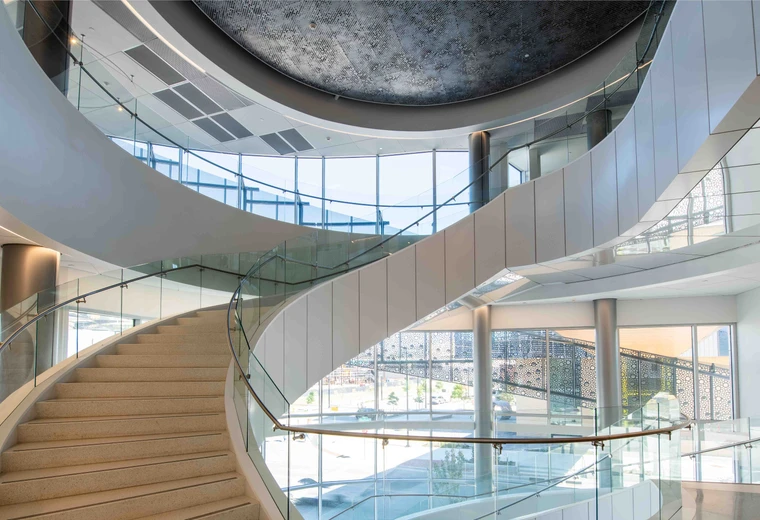 A spiraling staircase that connects 3 levels in a building.