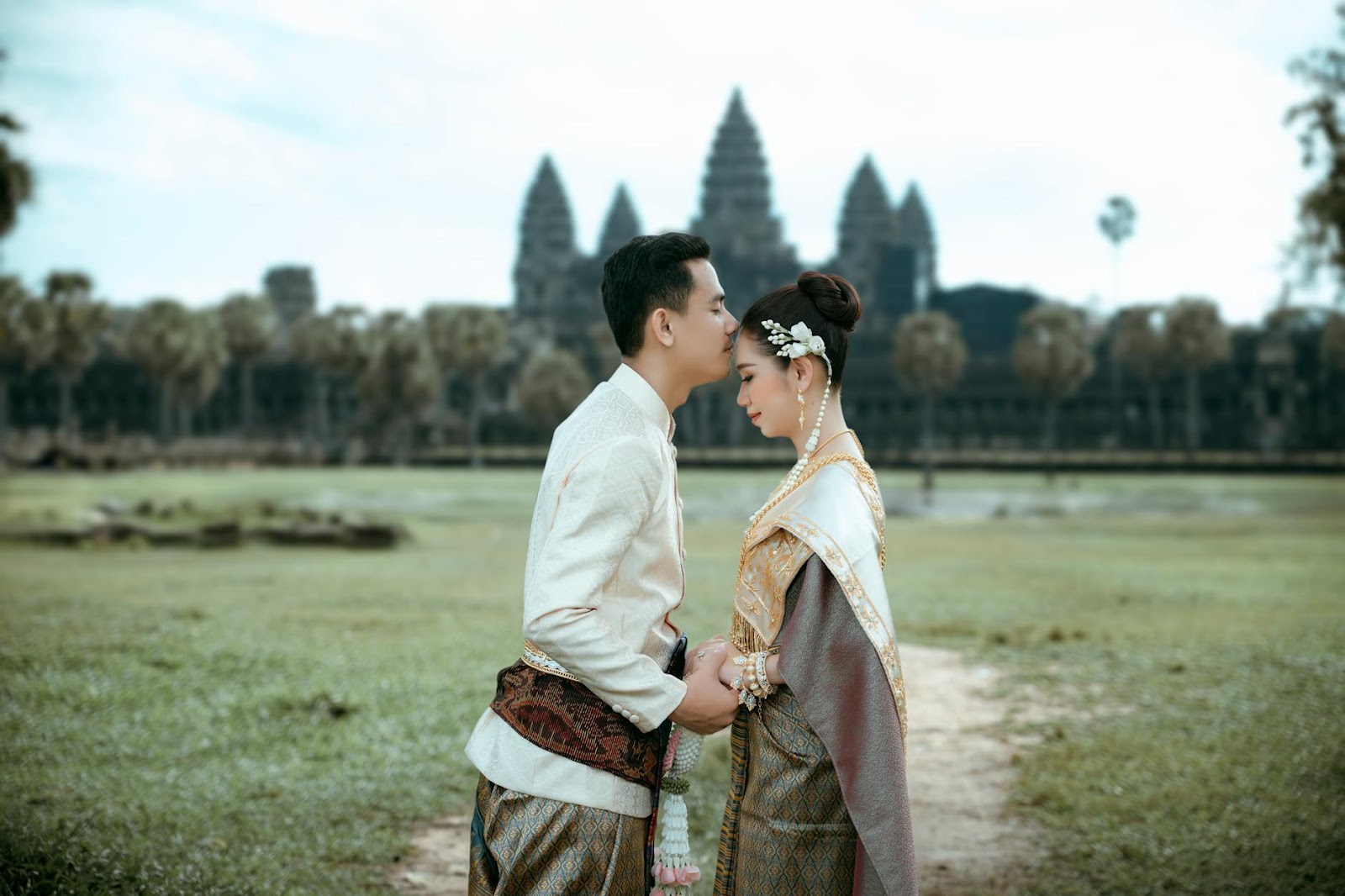 A person and person in traditional clothing kissing

Description automatically generated