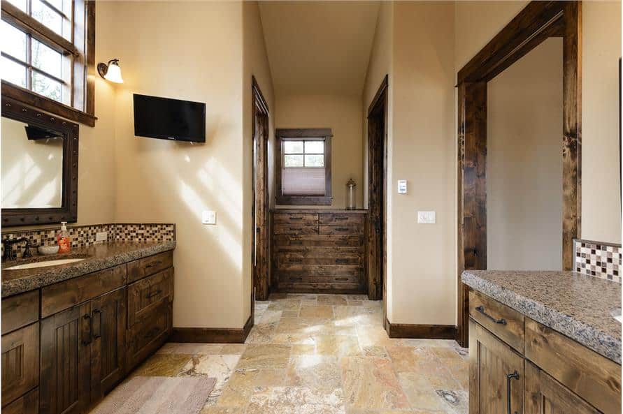 At the far end is a built-in cabinet flanked by a toilet room and walk-in shower.