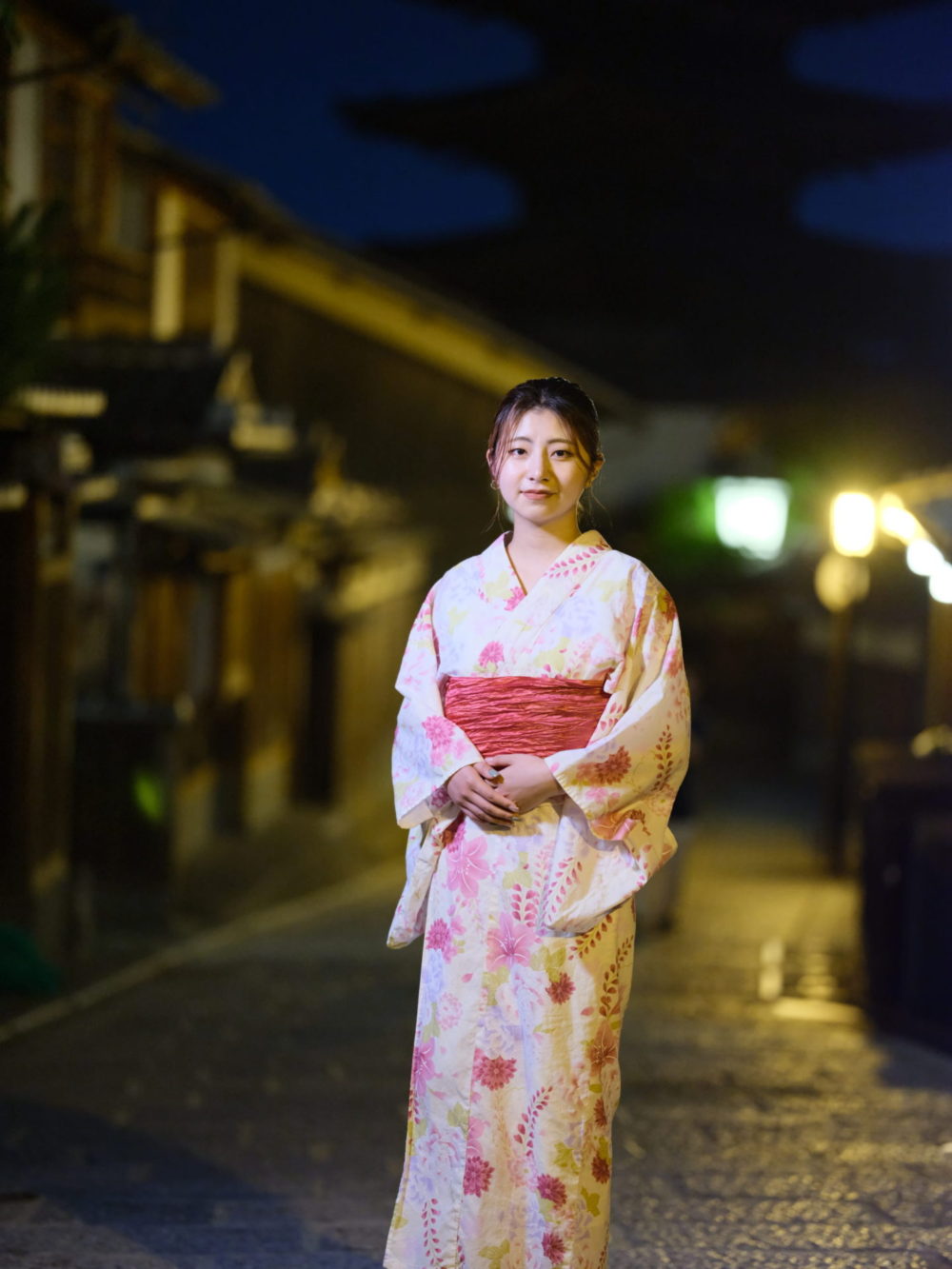 Professional kimono styling and photography setup in Kyoto showing traditional dress selection and fitting for night photography sessions