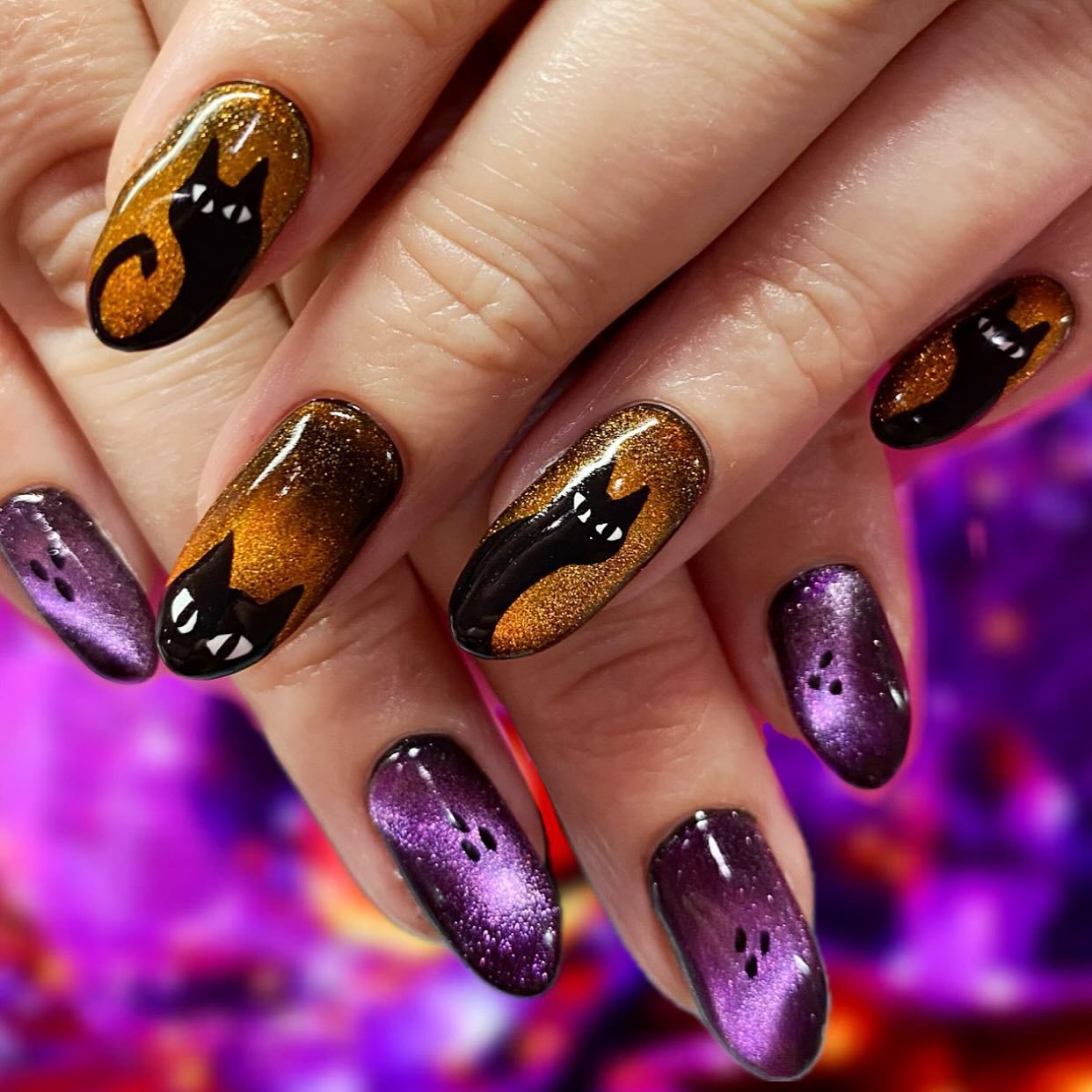 Close-up of hands with fall nail design having Black Cat Silhouettes