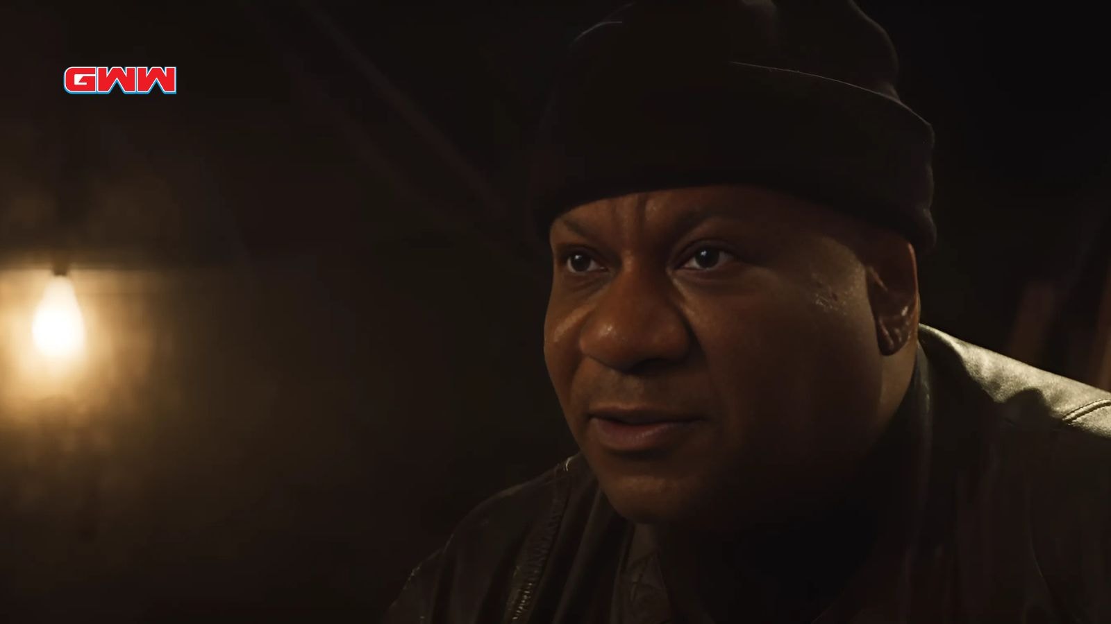 Close-up of Luther in a beanie with a focused expression.