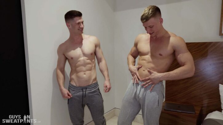 James Cassidy and Bryce Jax standing shirtless in grey sweatpants in guys in sweatpants gay xxx porn scene