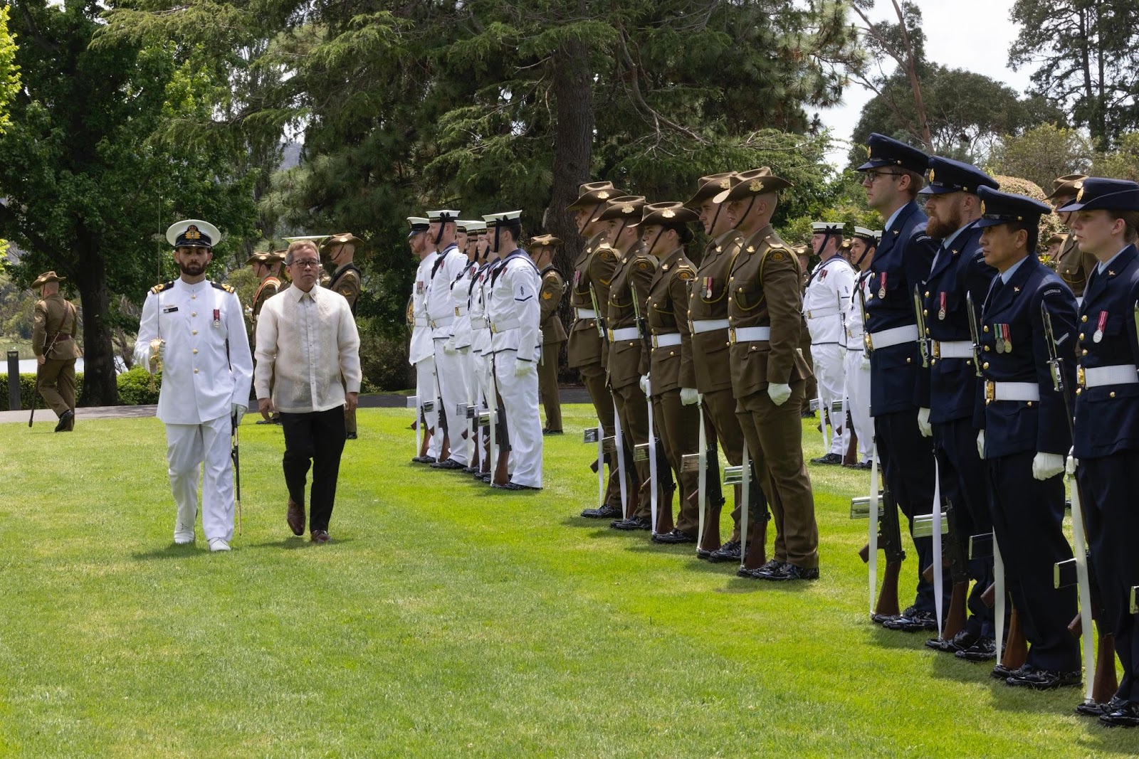 A group of people in uniform standing in a rowDescription automatically generated