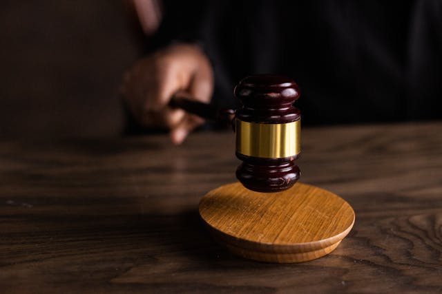 Person hitting a gavel on table 