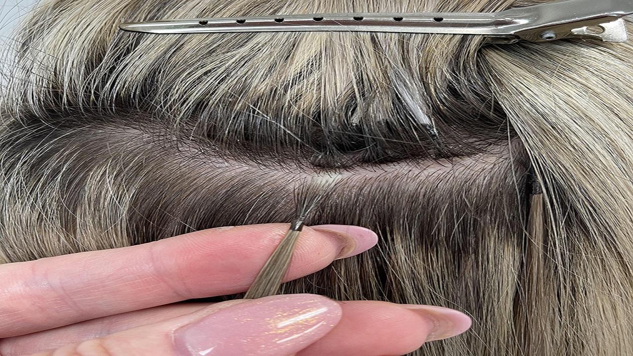 A person cutting hair with a tweezers