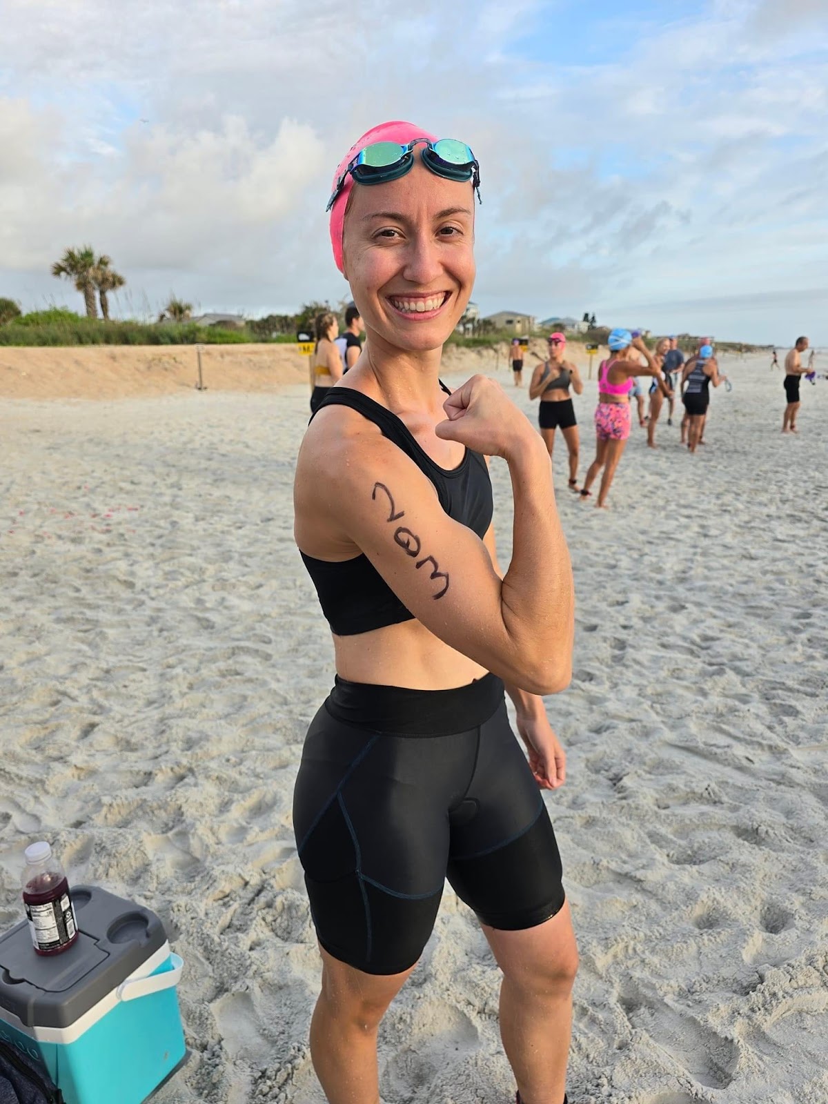 cortney welch flexing and prepping to start the swim portion of her triathlon