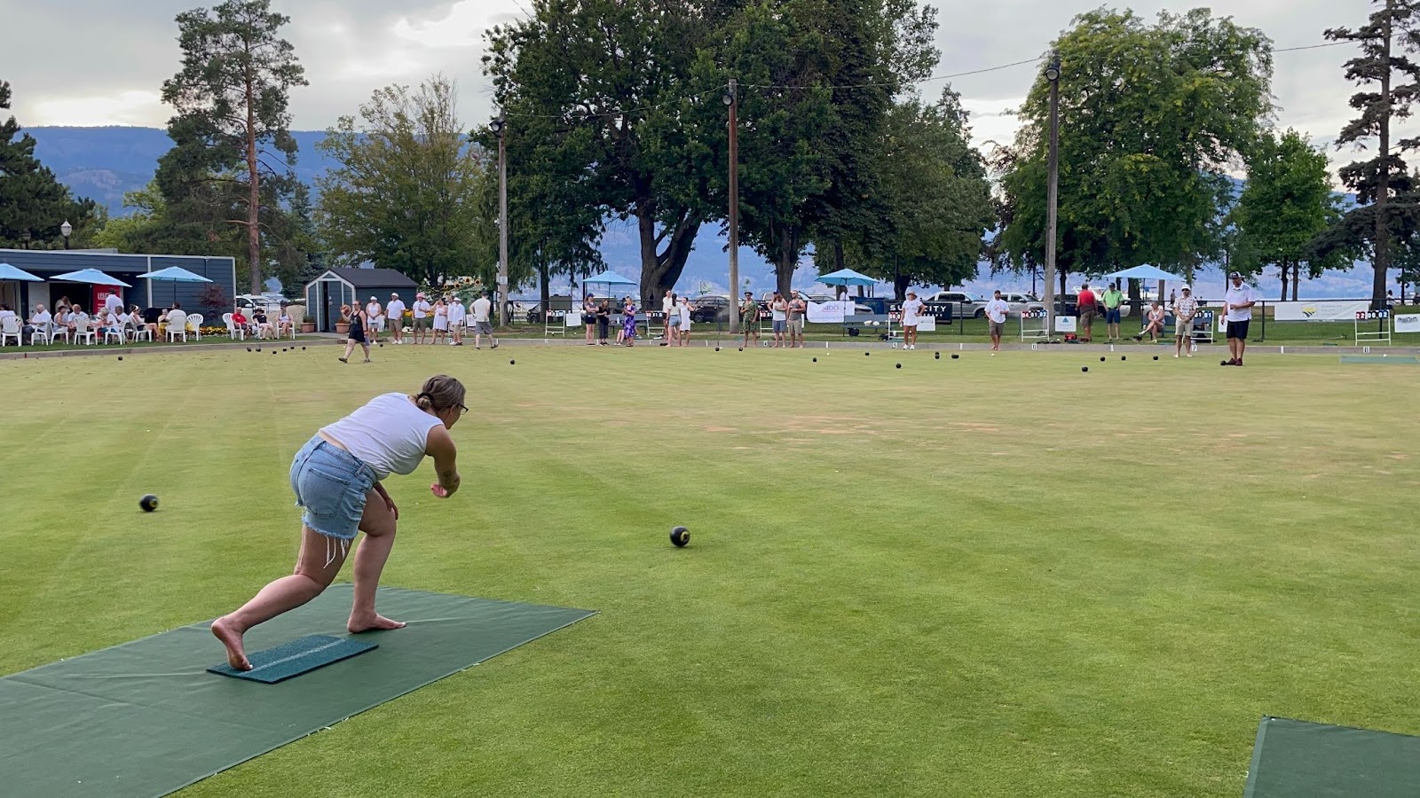 Image of Twirling Umbrellas staff member Carla Bardwell lawn bowling at the Kelowna Lawn Bowling Club. 