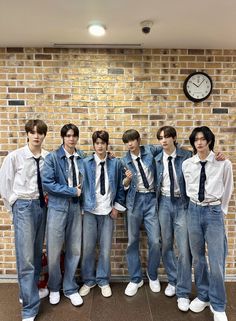 This  contain an image of RIIZE | SM Entertainment standing in front of a brick wall with a clock on the wall behind them