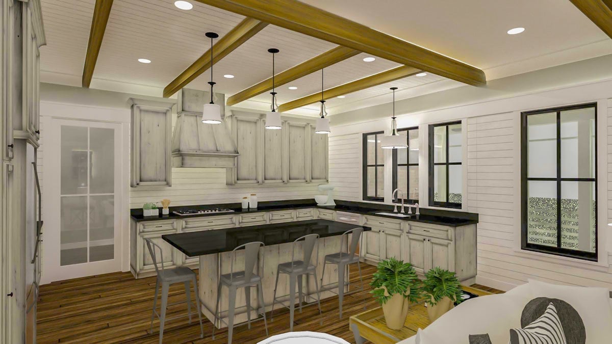 The kitchen is equipped with distressed white cabinetry, black granite countertops, a built-in cooktop, and a breakfast island.