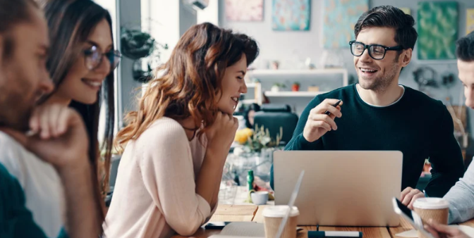 Happy people talking in an office about data automation
