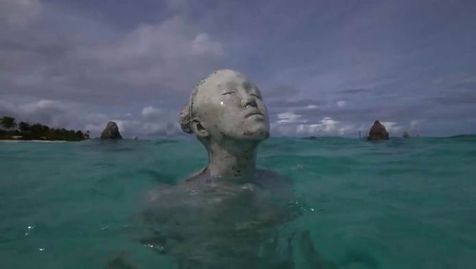 This may contain: there is a statue in the water with its head above the water's surface