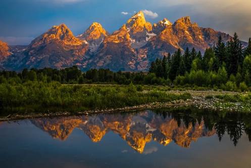 A mountain range reflected in water

AI-generated content may be incorrect.