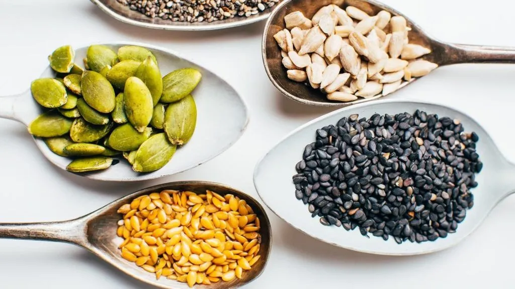 Nutrient-rich seeds like flax and chia shown as superfoods for how to have healthy hair from the inside out.