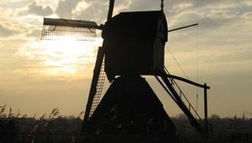 A silhouette of a windmill

Description automatically generated