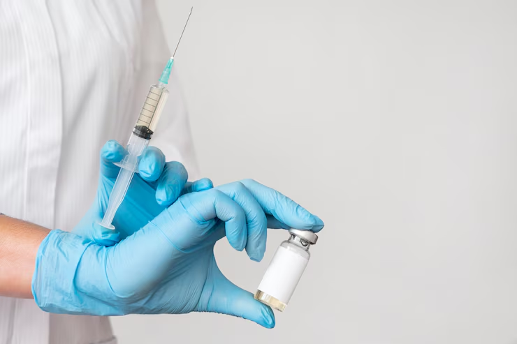 a-gloved-hand-holding-a-syringe-and-a-white-labeled-vial-against-a-gray-background-the-real-thymogen-benefits-theyll-never-mention-tony-huge