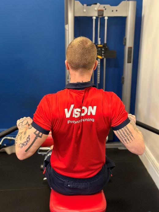 a Vision PT personal trainer using the wide grip cable row