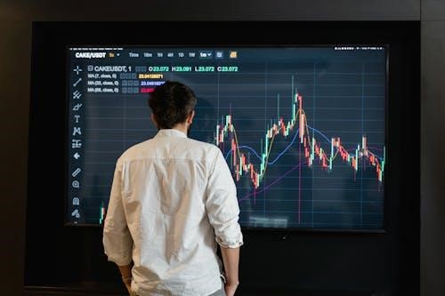 Free A Man in White Long Sleeves Looking at the Screen Stock Photo