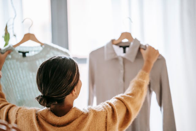 A woman choosing between two tops while using Kepner Tregoe for Making Decisions method