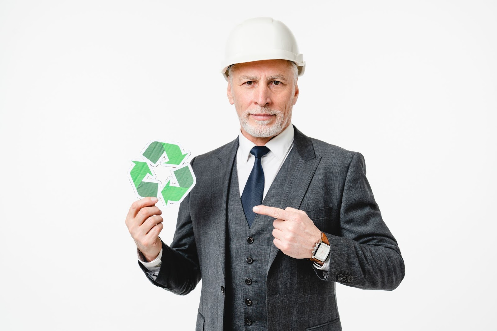 Man in a suit and a hardhat holding a recycling symbol. 