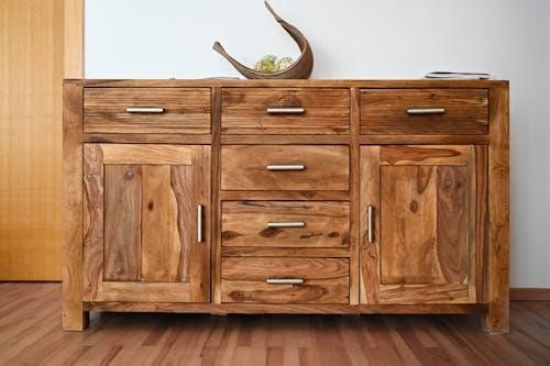 Free Beautiful wooden cabinet with sleek handles and natural wood grain, ideal for stylish interiors. Stock Photo