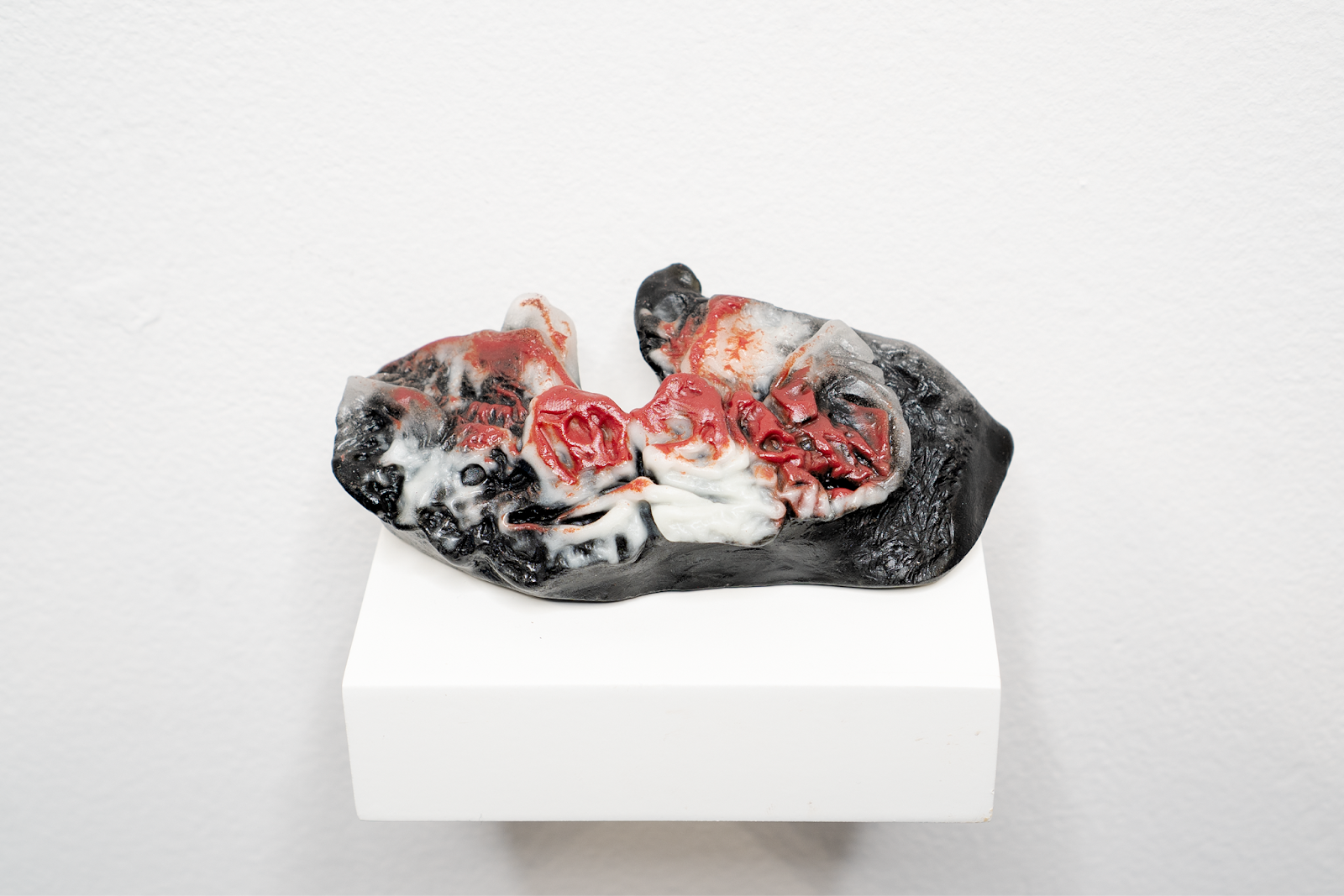 Image: QUEER DEITY IX (Kinship and Food Sharing), 2023, cast glass, 1.5 x 4.5 x 1.5 in., 3.8 x 11.43 x 3.8 cm. Black, red, and white cast glass sculpture of two Vampire Bats feeding each other on a white shelf floating on a white wall. Photo: Levi Shand, Fabrication: D Rosen, S12, USF Verftet, Firebird Community Arts, and Andrew Bearnot, Grant: DCASE, 2024.