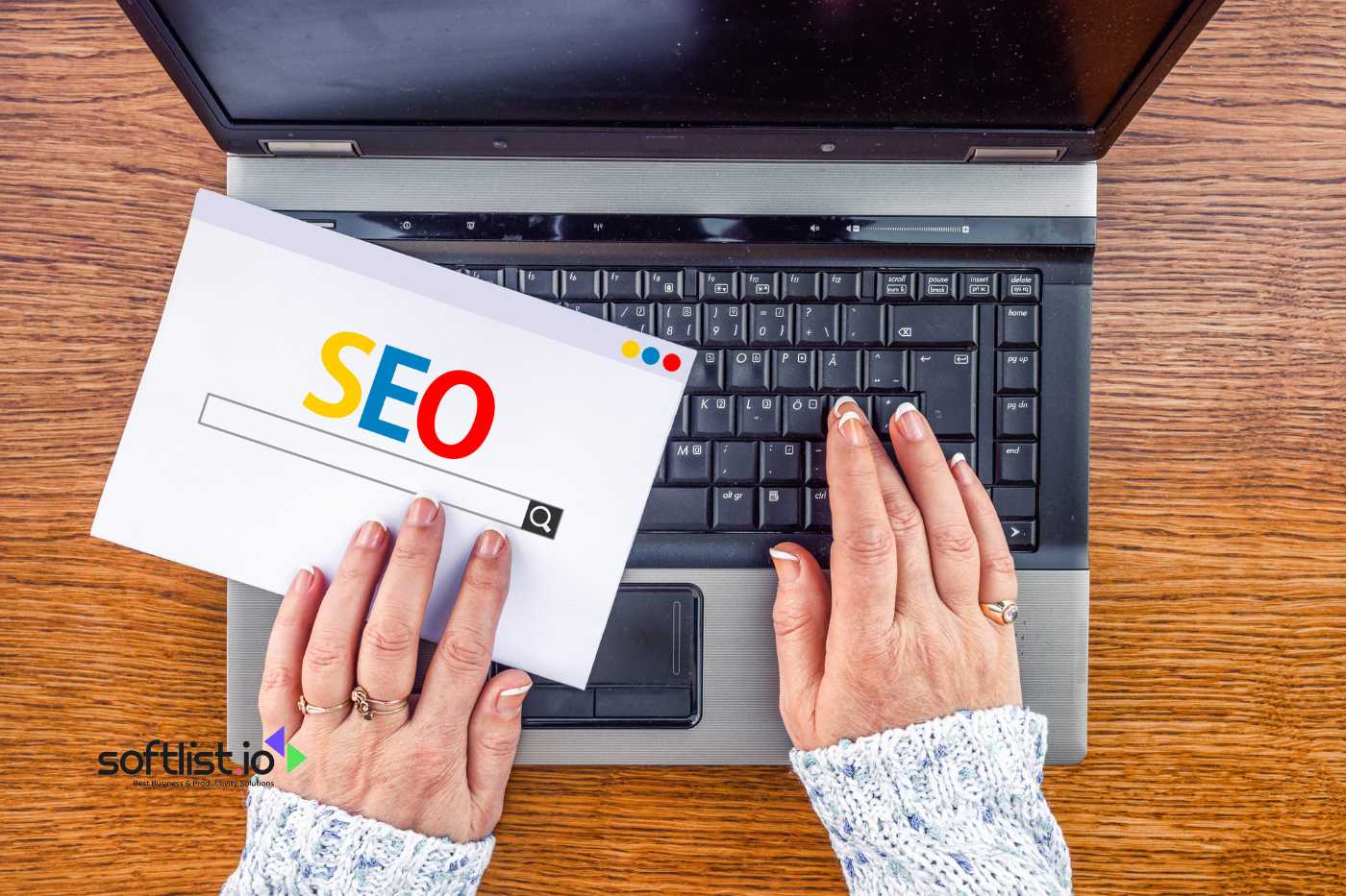 a hand typing to his laptop with seo letter