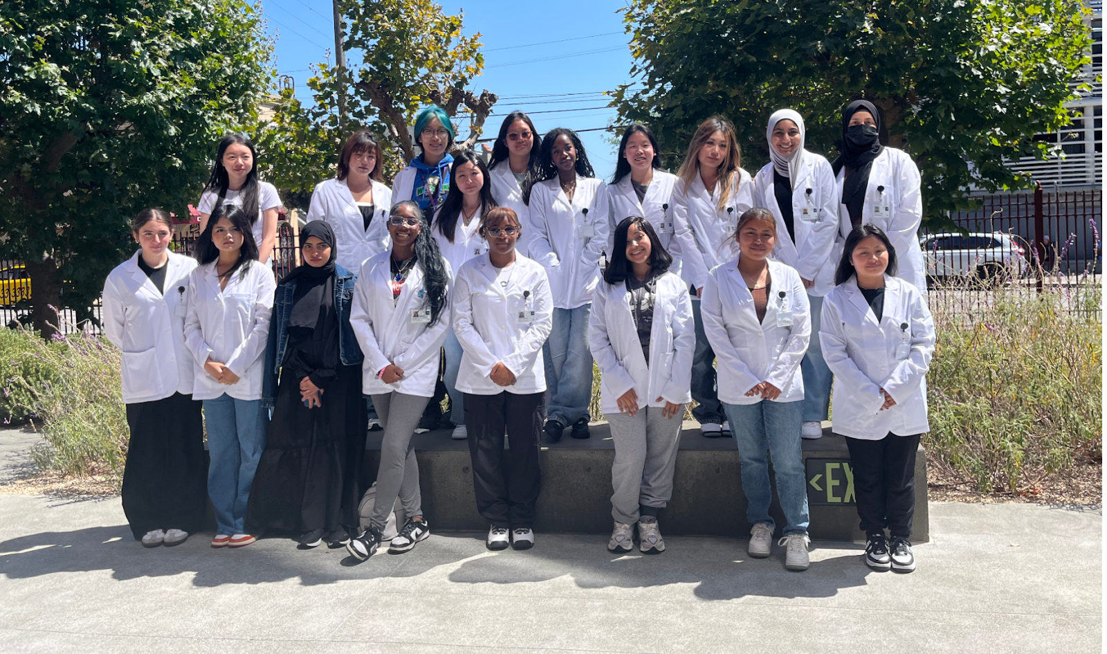 A group of people in white lab coats

Description automatically generated