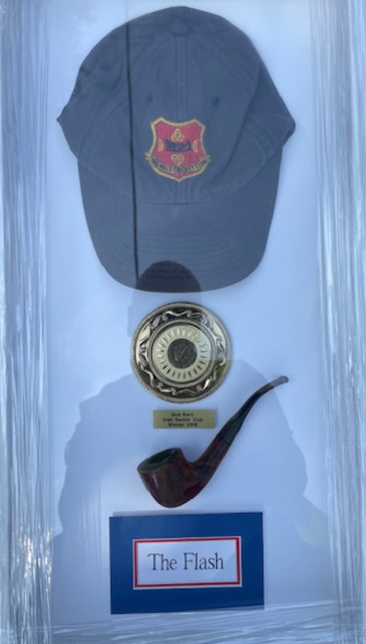 A hat and pipe in a case

Description automatically generated