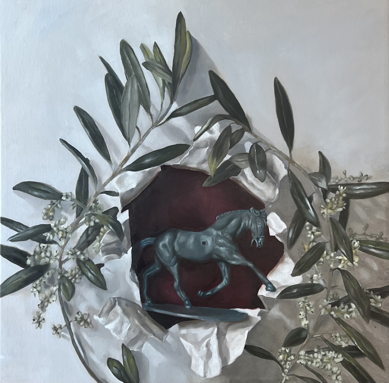 A painting of a toy horse surrounded with leaves. 