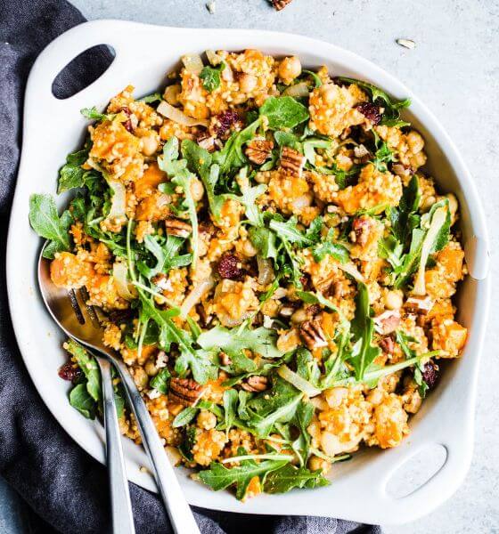 Sweet potato salad in white serving bowl with spoon