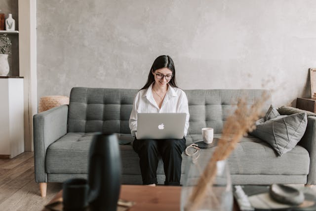 Person working on a computer on a couch