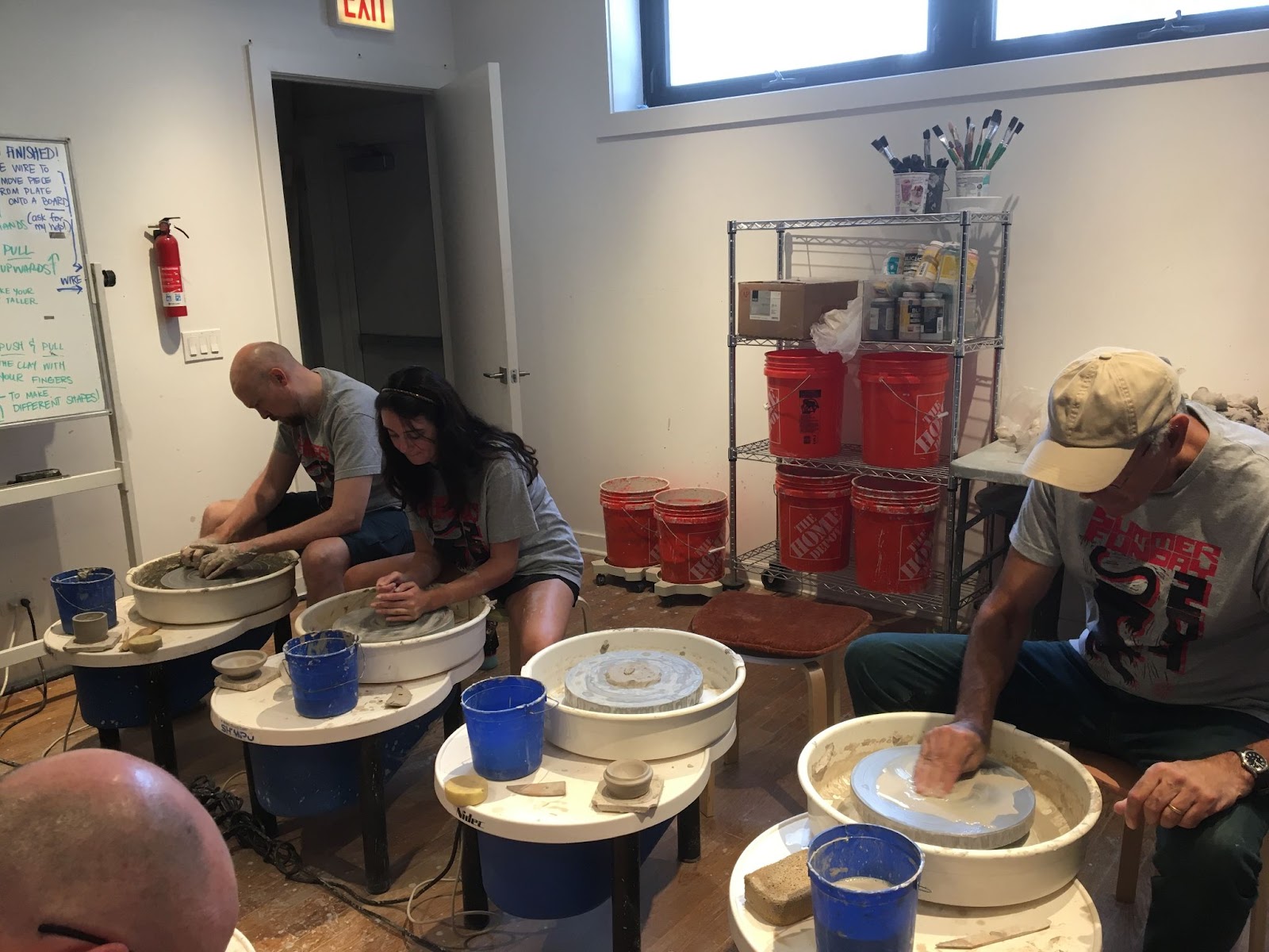 Team members spinning clay