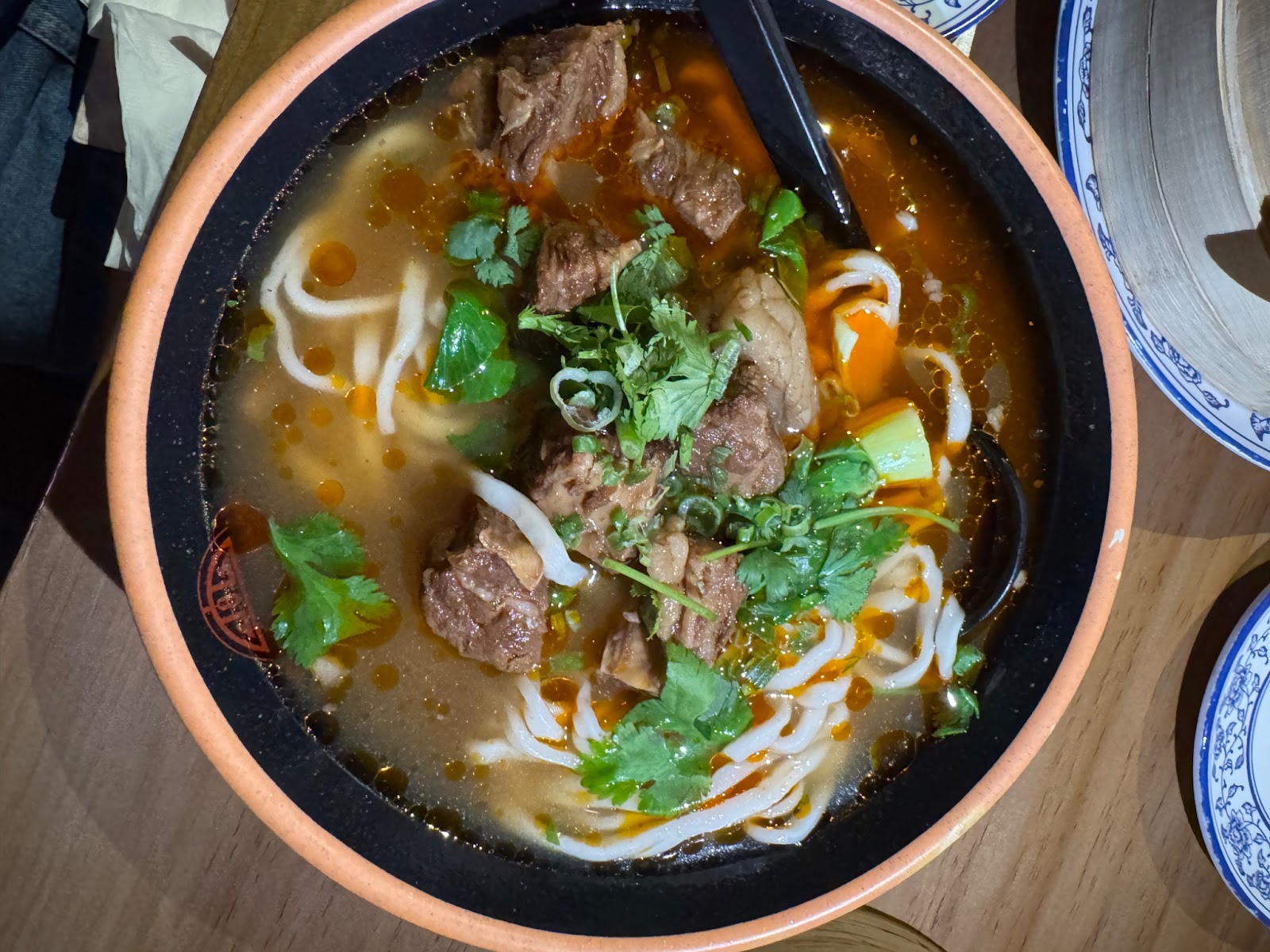 Beef brisket and noodles in a spiced broth with cilantro and scallions