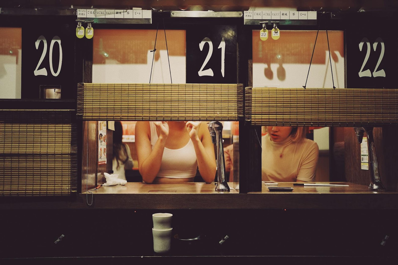 Intimate dining experience at a ramen restaurant in Shibuya, Tokyo with individual booths.